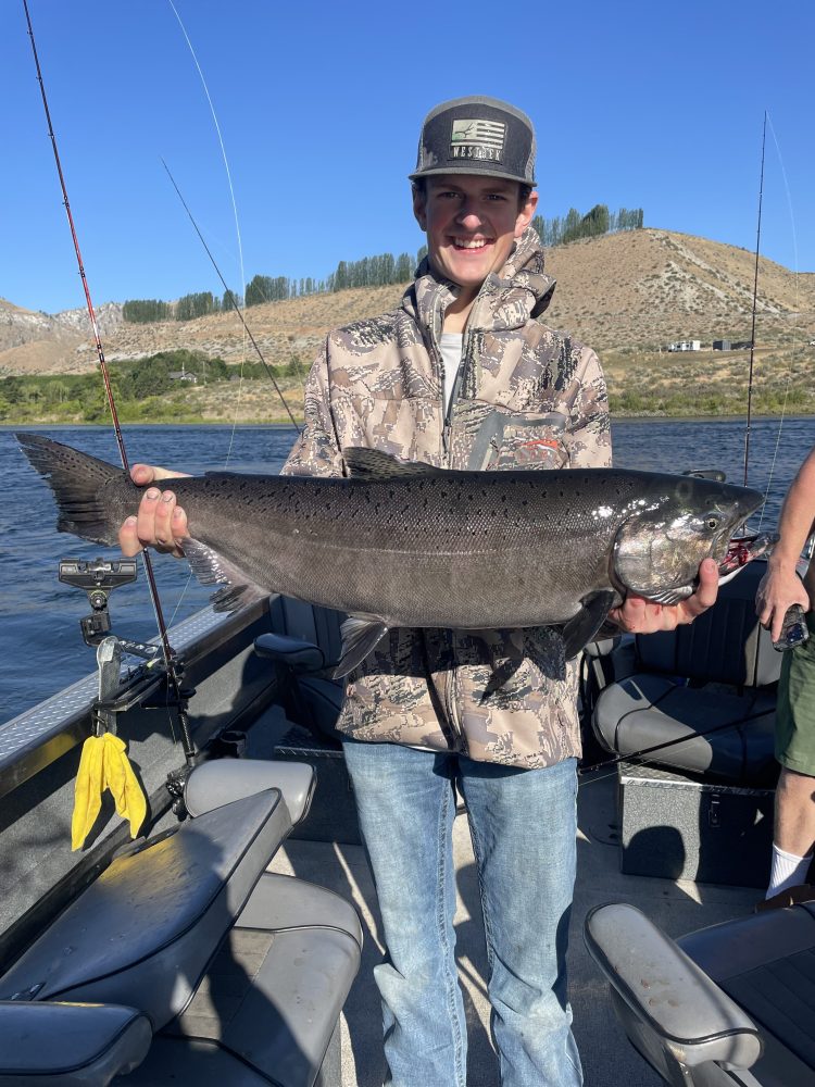 a person holding a fish in the water