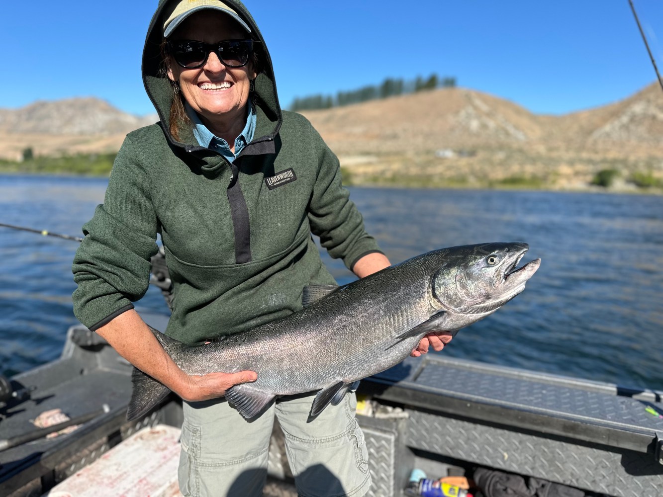 a person holding a fish in the water